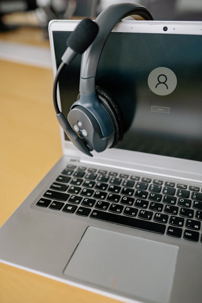 our-services-1 Close-up of a laptop with a headset, symbolizing online communication and remote work.